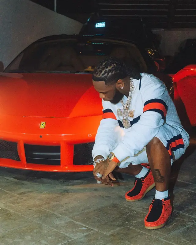 Burna Boy outfit in Gucci, Clarks, and Popcaan Merch, 2024