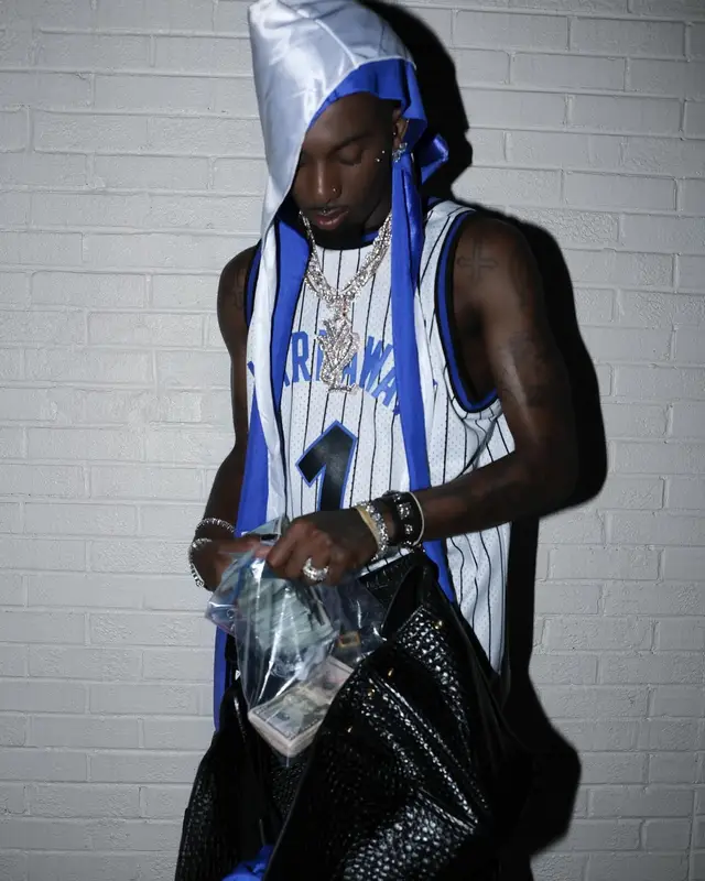 Playboi Carti outfit in Mitchell & Ness, Timberland, and Chrome Hearts, 2024