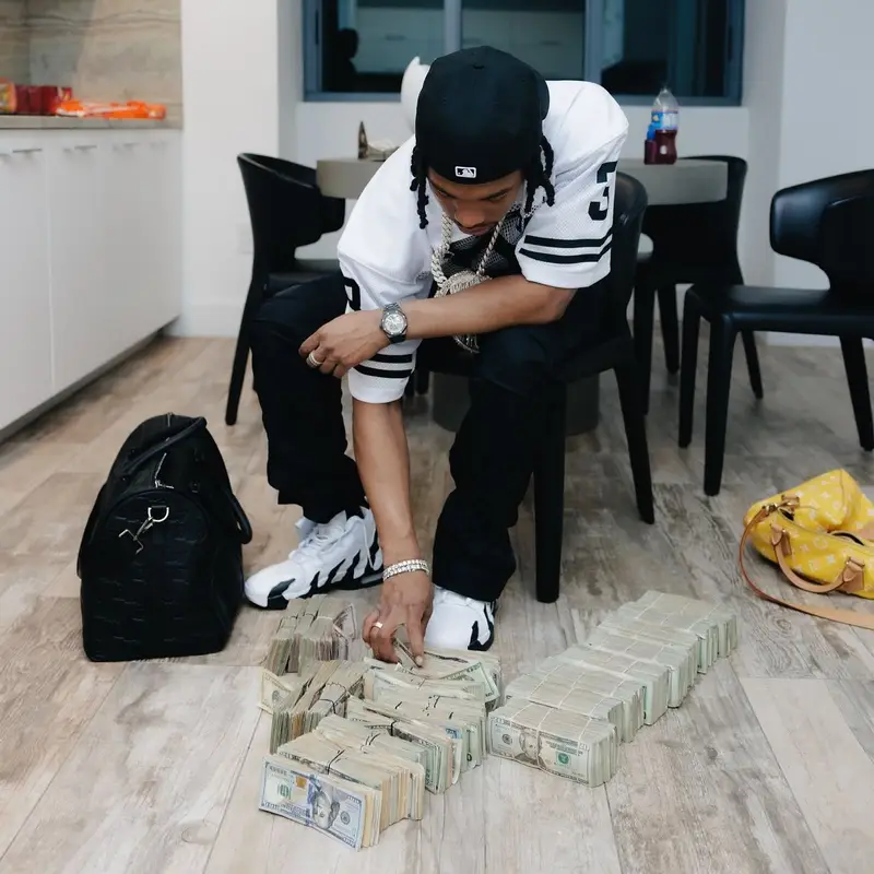 Lil Baby outfit in Nike, Louis Vuitton, and New Era, 2025