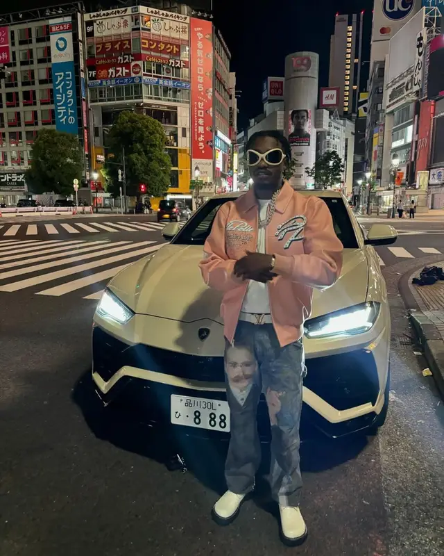 Lil Tjay outfit in Who Decides War, Audemars Piguet, and Acne Studios, 2025