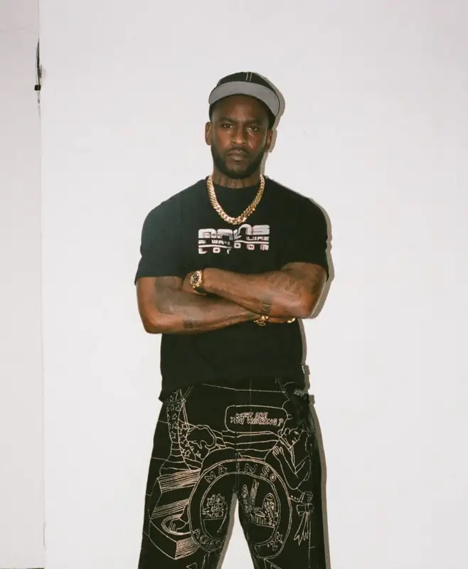 Skepta outfit in New Era, Mains, and Kickers, 2025