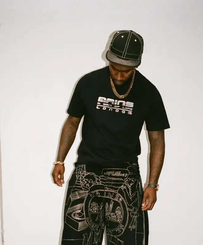 Skepta outfit in New Era, Mains, and Kickers, 2025