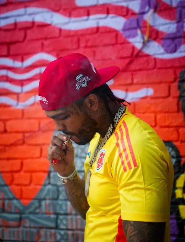 Dave East outfit in Adidas, Champion, and Louis Vuitton, 2025