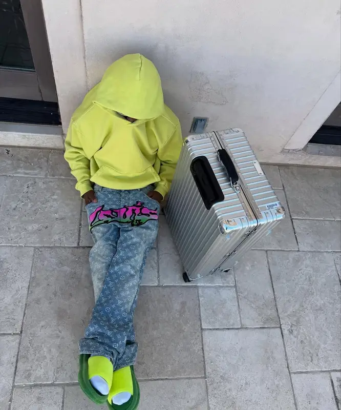 Kai Cenat outfit in Louis Vuitton, Rimowa, and Skylrk, 2025