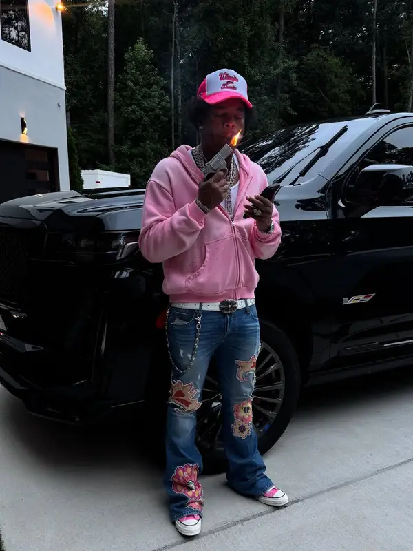 Lil Baby outfit in Converse, Chrome Hearts, and Wooooo! Energy Drink Merch, 2025