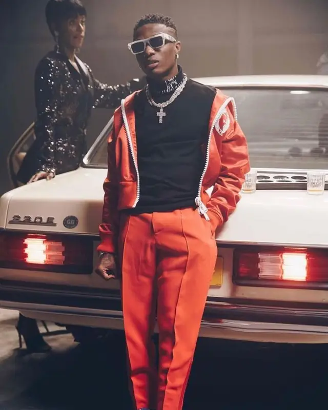 Wizkid outfit in Versace, Marc Jacques Burton, and Louis Vuitton, 2021