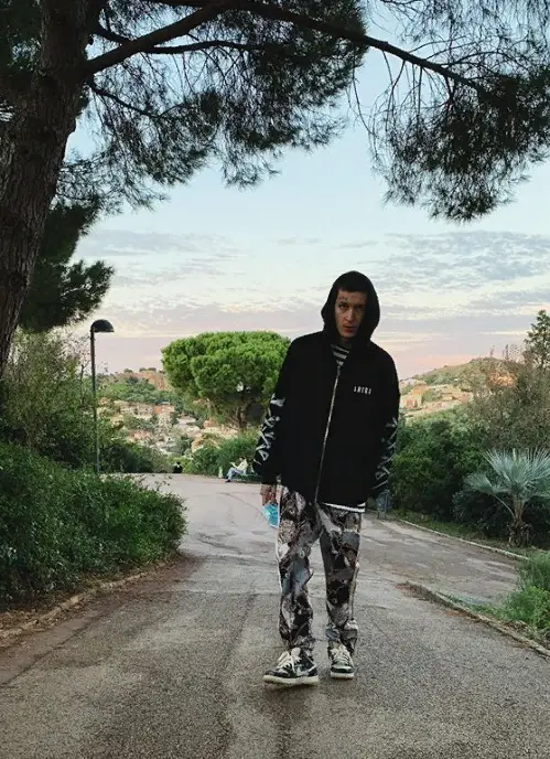 Kizaru outfit in Amiri, Comme Des Garcons, and Palm Angels, 2020
