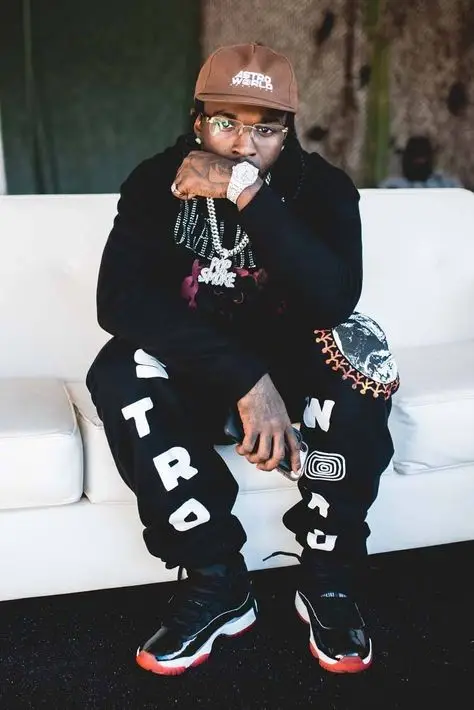 Pop Smoke outfit in Champion, Jordan, and Travis Scott Merch, 2019