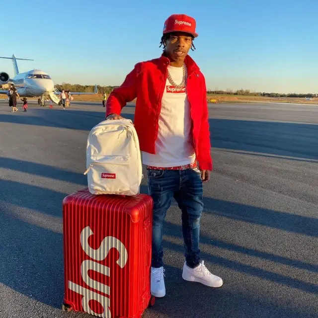 Lil Baby outfit in Louis Vuitton, Supreme, and New Era, 2020