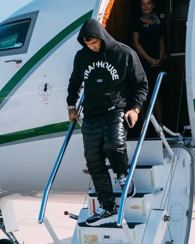 Anuel AA outfit in Empty Infamous, Moncler, and Versace, 2019