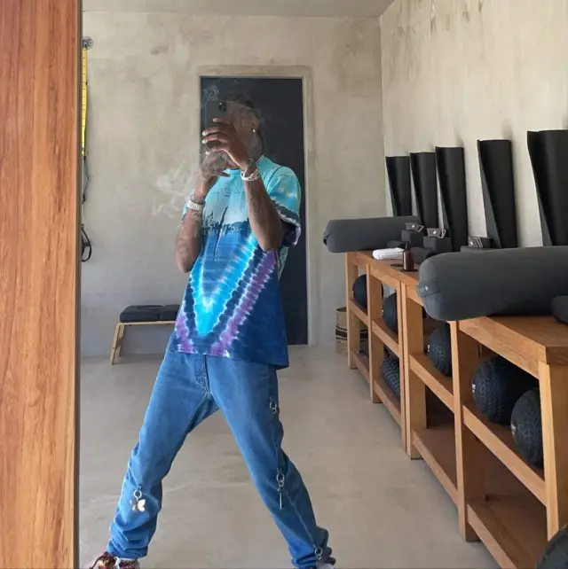 Travis Scott outfit in Pink Floyd Merch, Raf Simons, and Lanvin, 2020