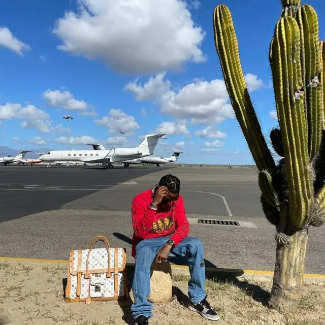 Travis Scott outfit in Raf Simons, Nike, and Supreme, 2020
